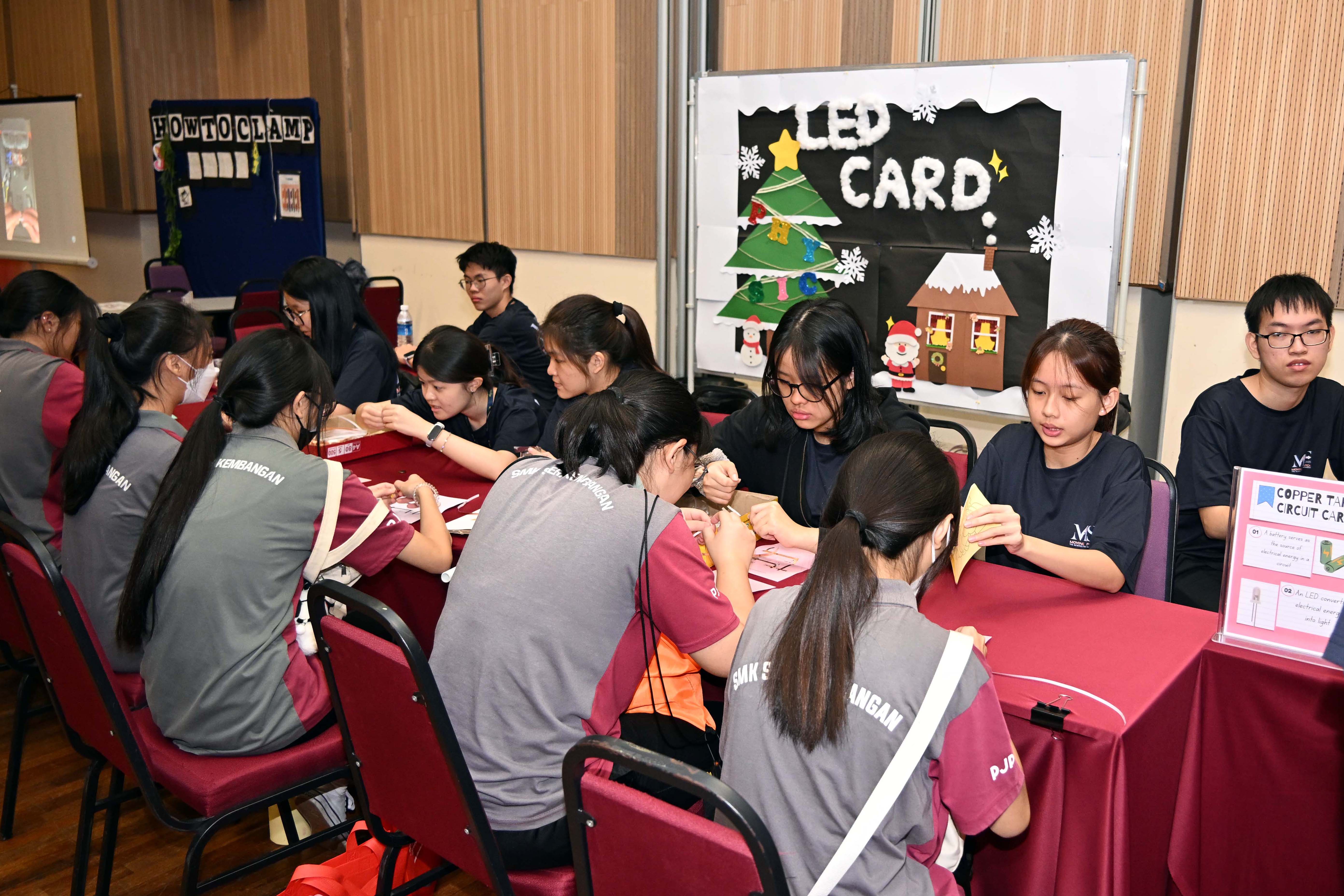 High schoolers participating in the activities in each booth