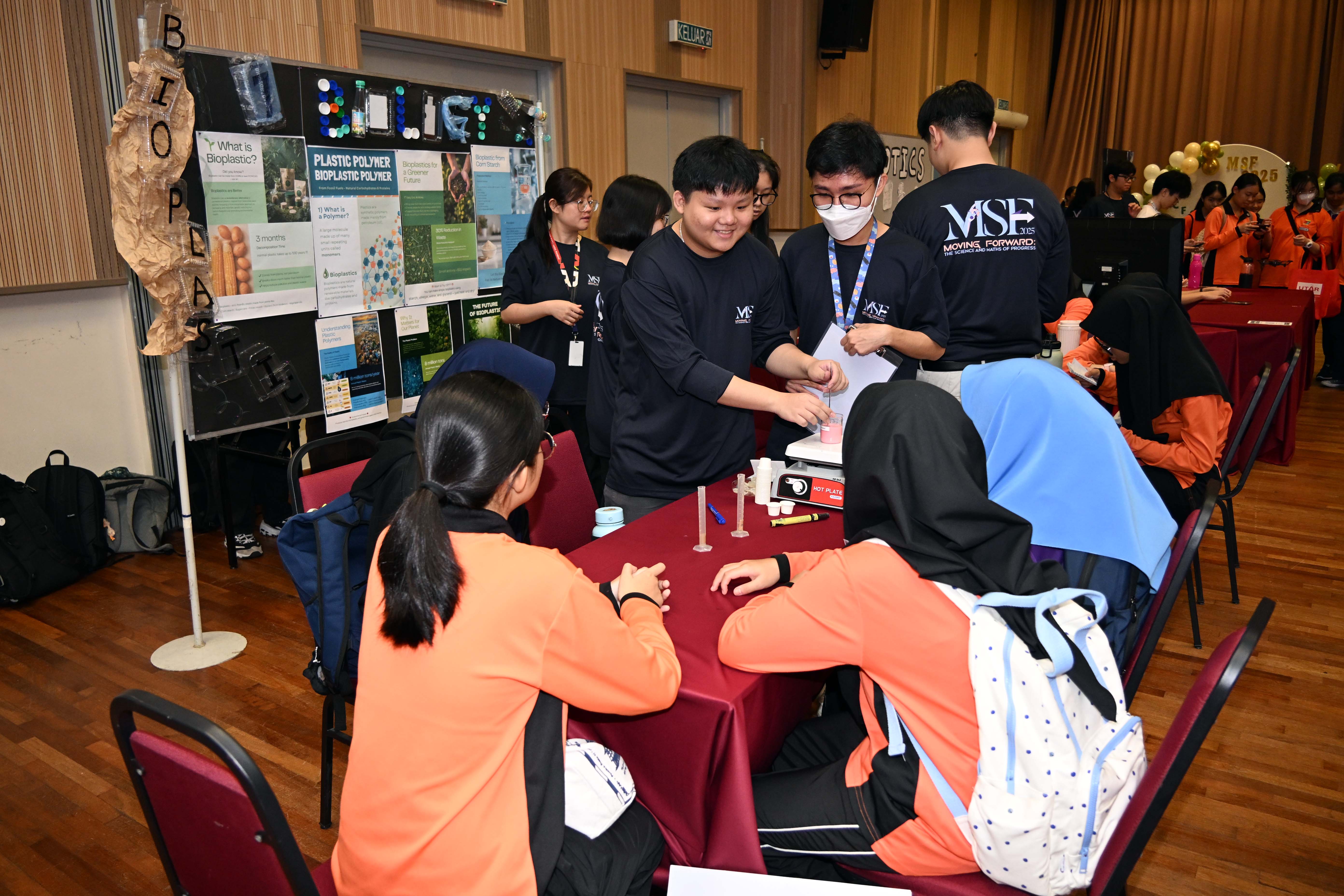 High schoolers participating in the activities in each booth