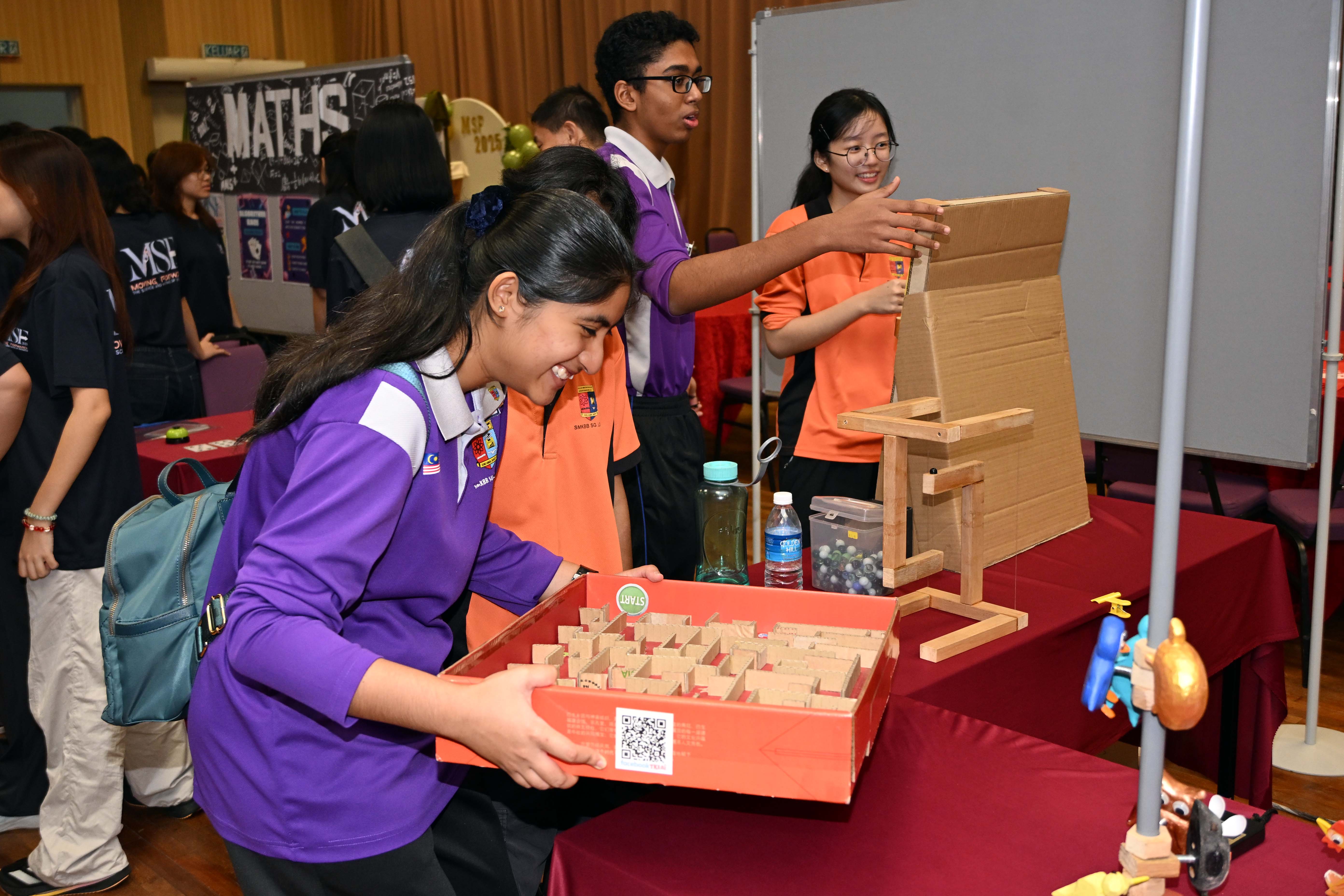 High schoolers participating in the activities in each booth