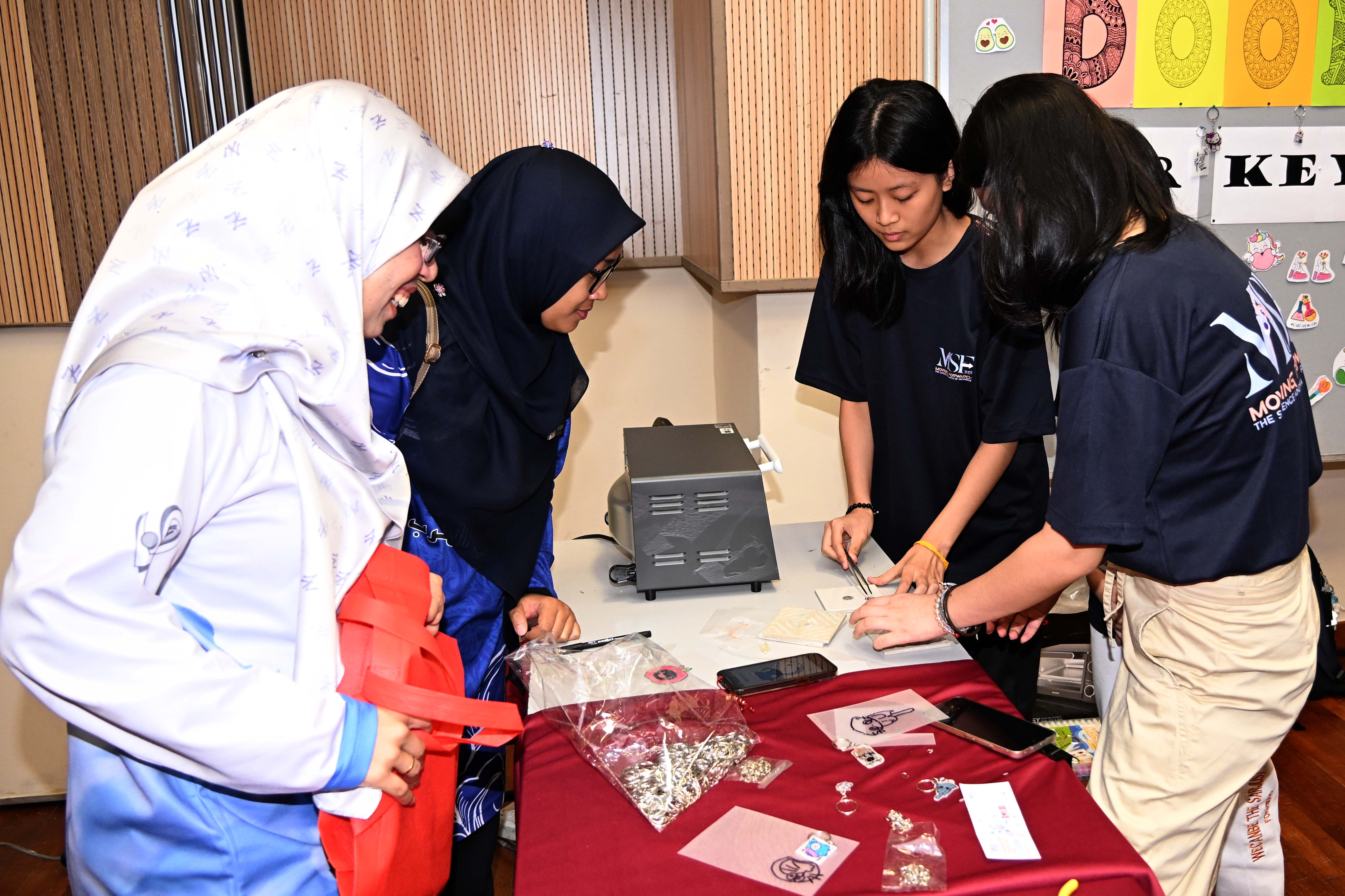 High schoolers participating in the activities in each booth