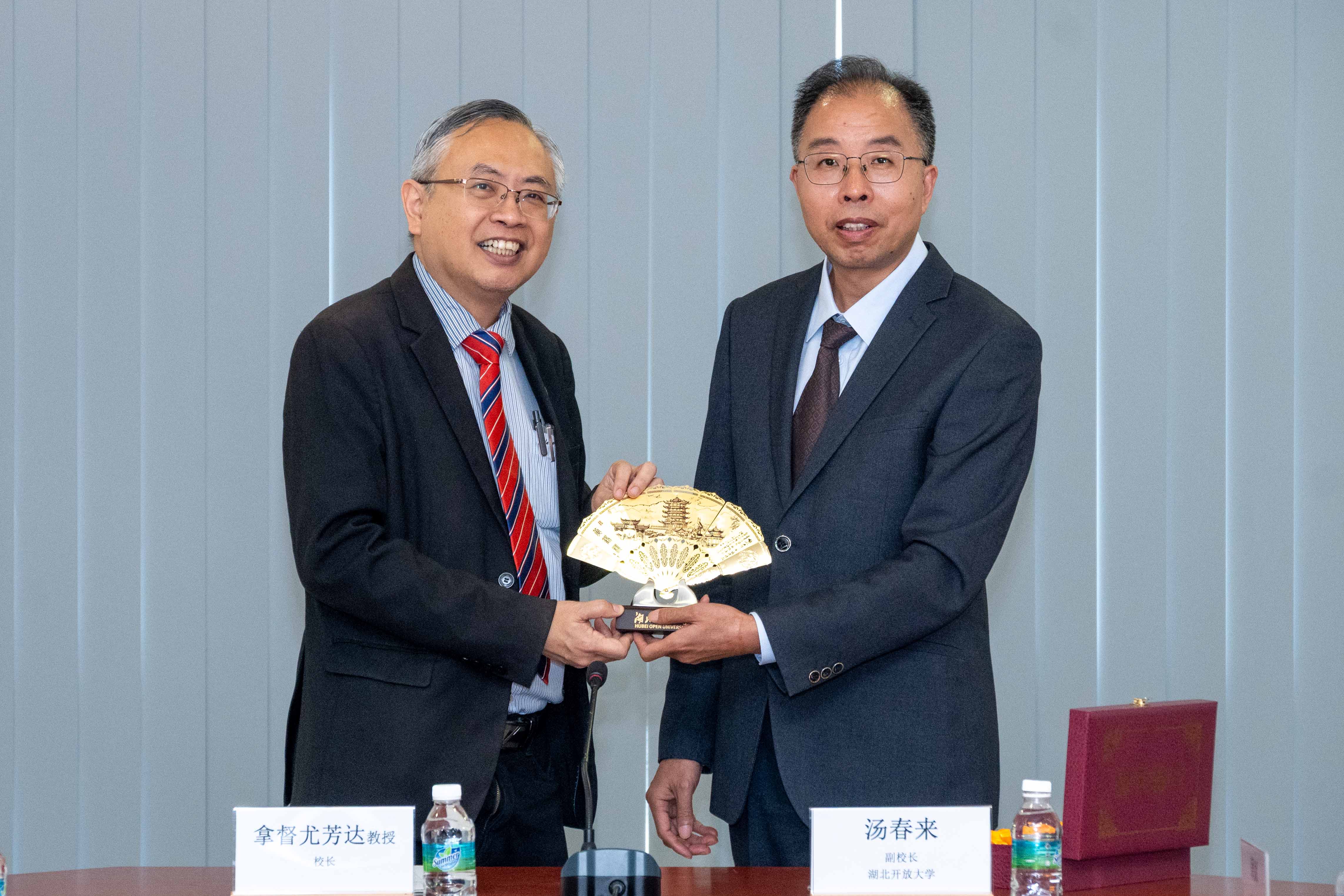 Prof Dato’ Ewe (left) and Prof Tang exchanging souvenirs as a symbol of goodwill