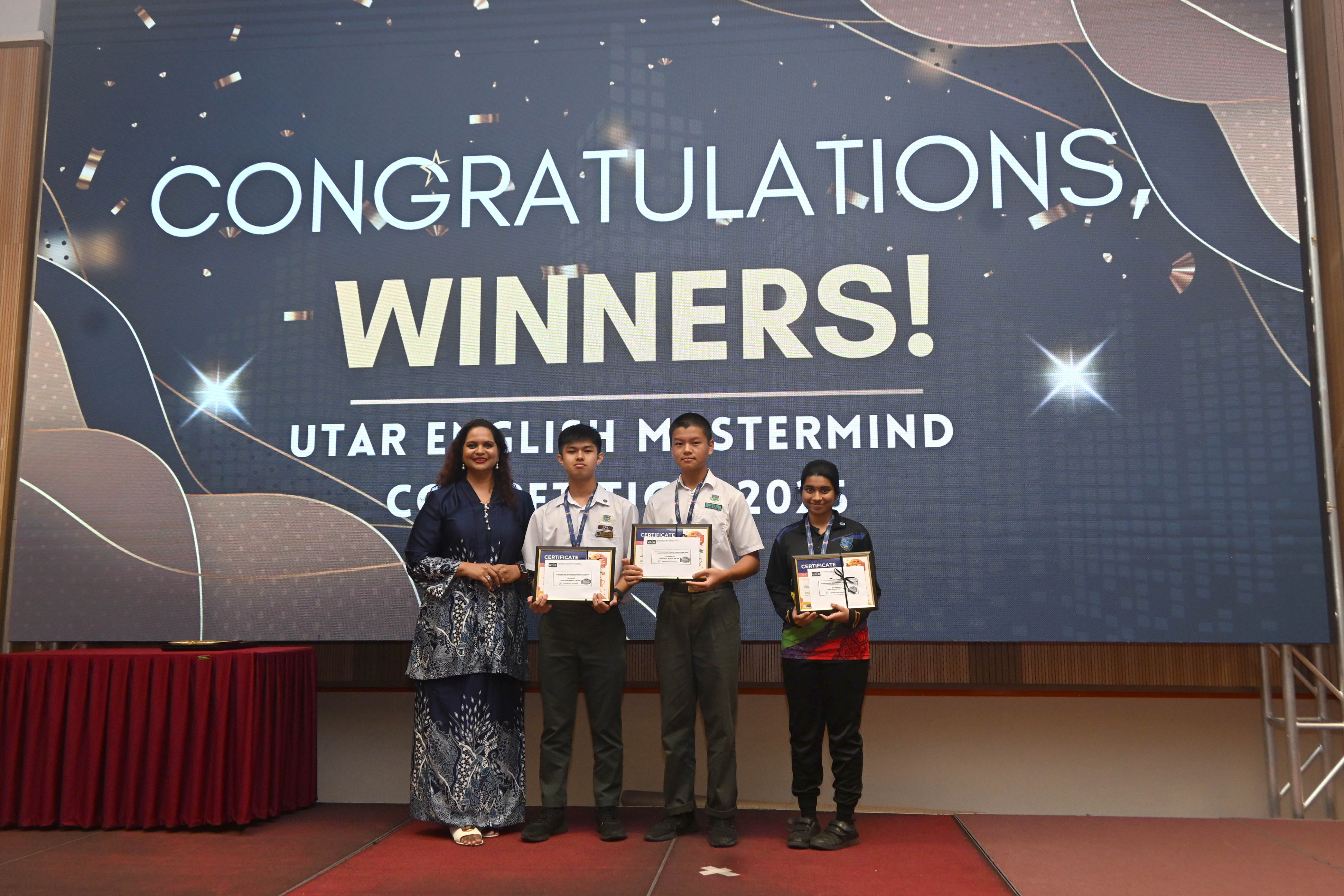 From left: Ms Melissa with the winners of the UTAR English Mastermind Competition 2025 Jove Lee, Liew and Bhairavi