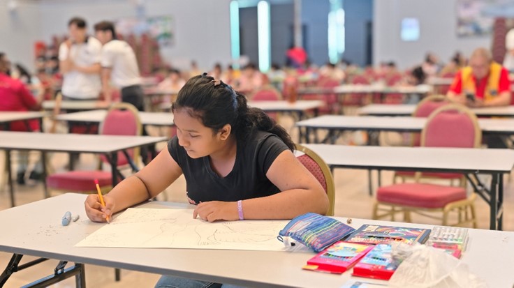 A young artist expressing creativity during the poster contest