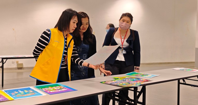 Judges evaluating the posters (from left) Ms Ng Wah Leng, Ms Haw Ai Peng and Ms Foo Pik Yin