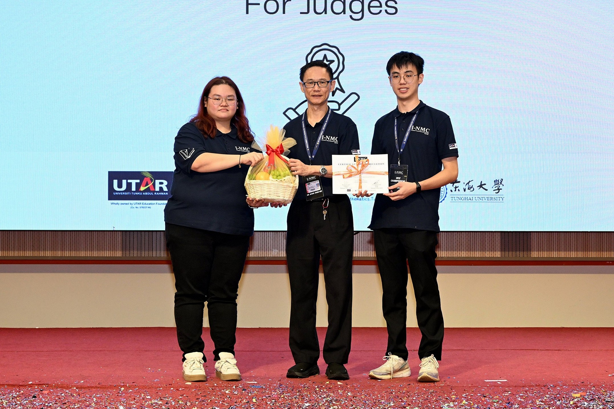 From left: Tan presenting a token of appreciation to Dr Wong, who represented the judges