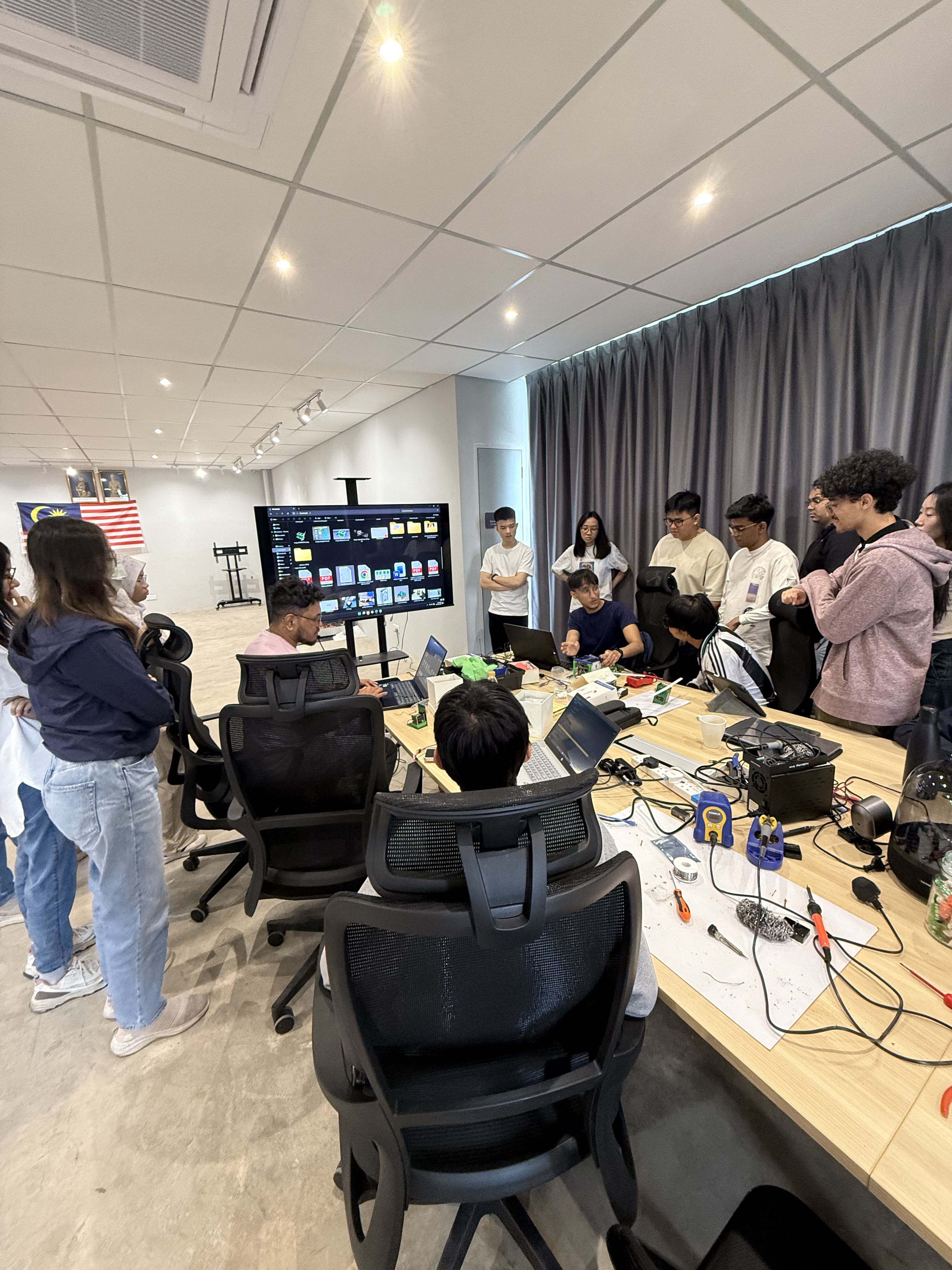 Behind the scenes of a build. Collaborative energy and complex circuitry in full swing.