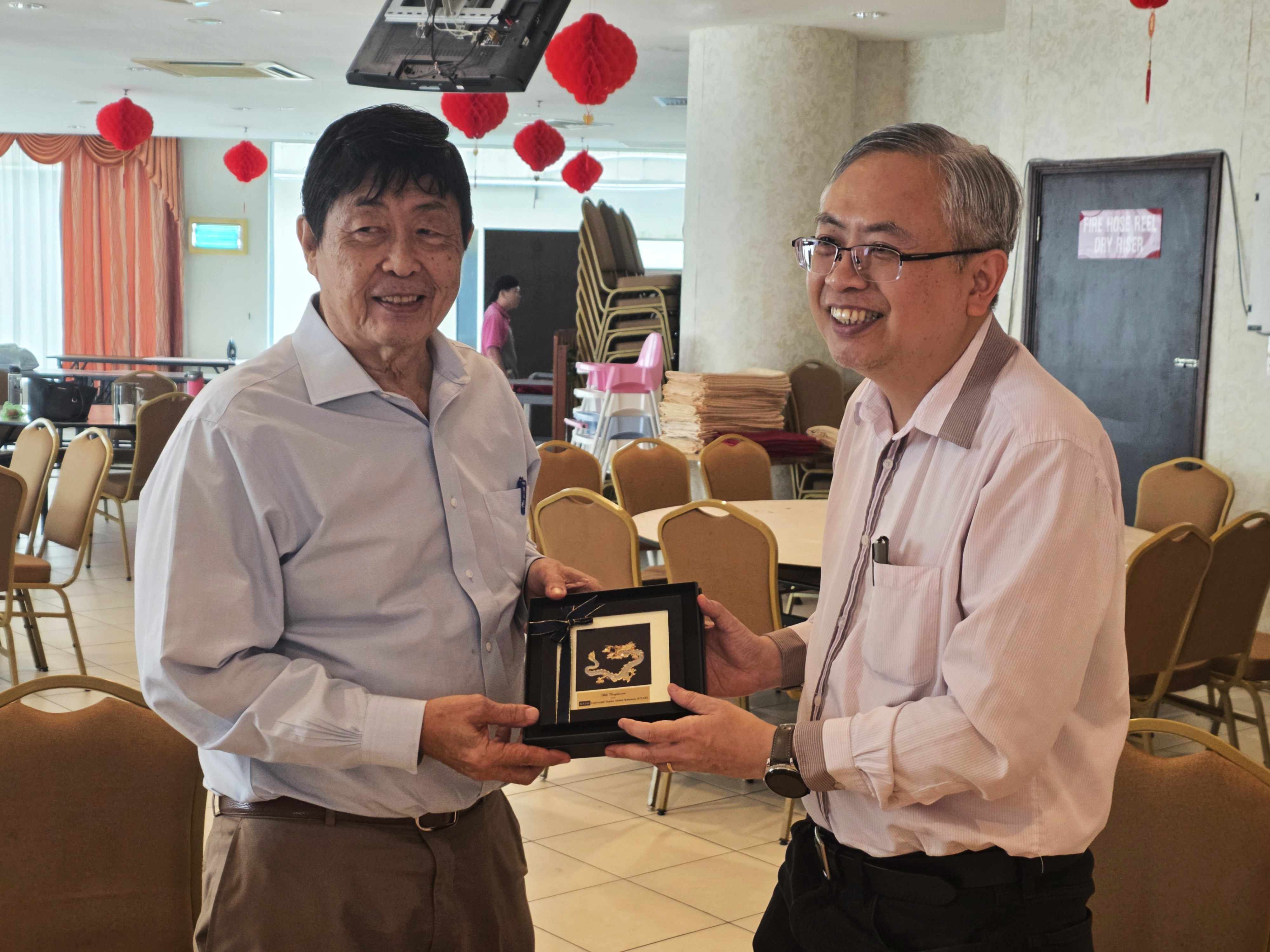 Prof Dato’ Ewe (right) presenting a token of appreciation to Mr Yu